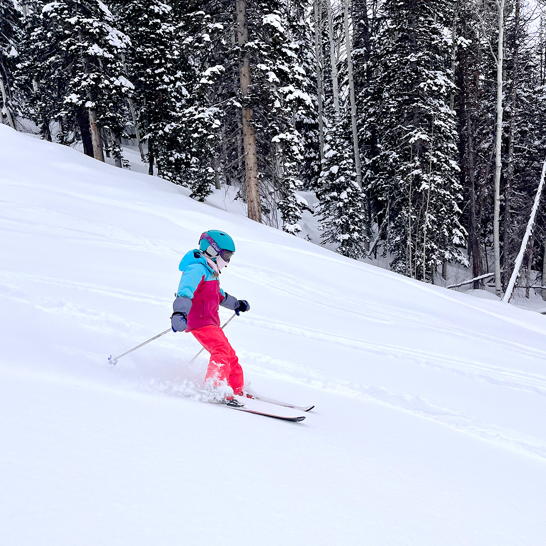 Skier carving fresh corduroy